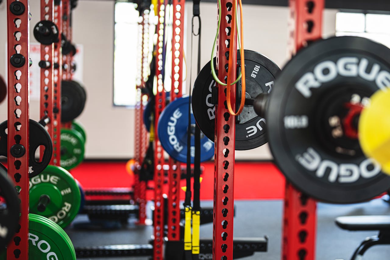 Colorful weightlifting equipment in a contemporary gym setting showcasing strength training options.